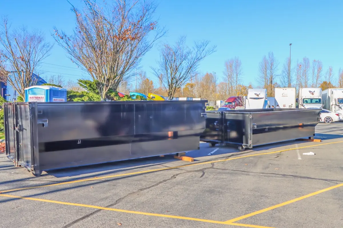 Professional dumpster rental service with roll-off container on residential driveway in Fish Hawk